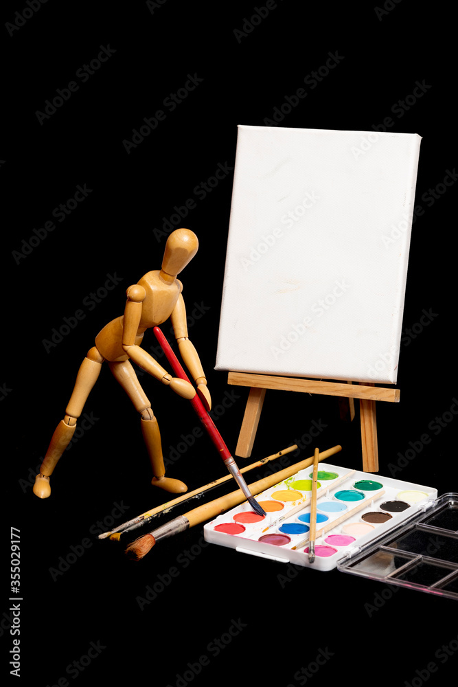 Wooden Manikin artist creates a painting Wooden Manikin artist creates a painting
