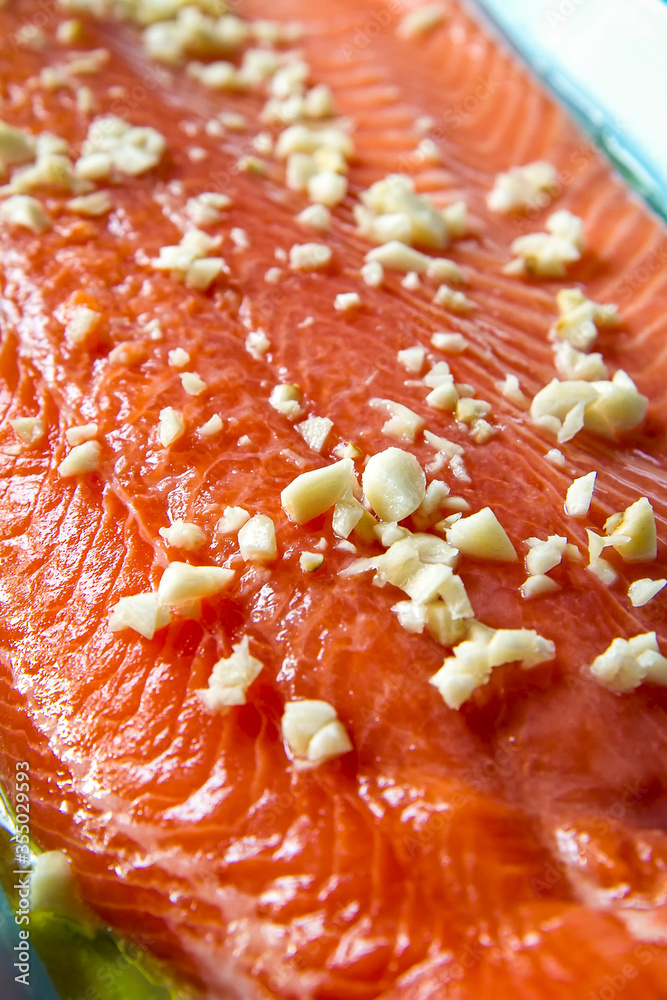 Salmon with garlic chunks prepared for grilling Salmon with garlic chunks prepared for grilling