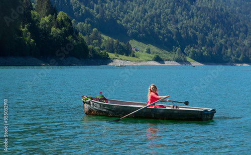 romantic scene with female model with long blond hair on a boat. © Peter Hofstetter