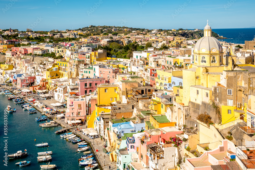 Colorful housing of Corricella fishing port on Procida island near Naples, Italy