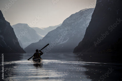silhouette of a man in a kayak