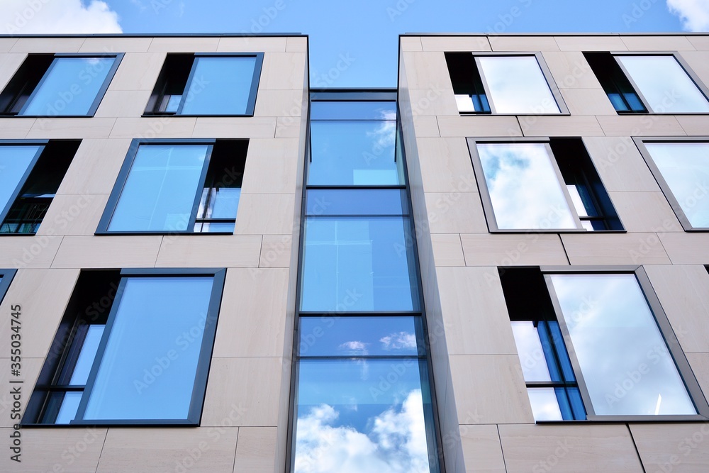 Facade texture of a glass mirrored office building. Fragment of the facade. Modern architecture of the office building.