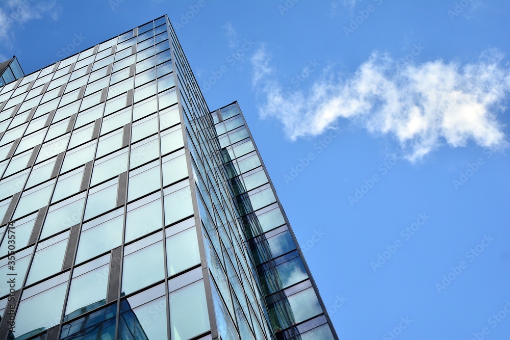Facade texture of a glass mirrored office building. Fragment of the facade. Modern architecture of the office building. Facade texture of a glass mirrored office building. Fragment of the facade. Modern architecture of the office building.