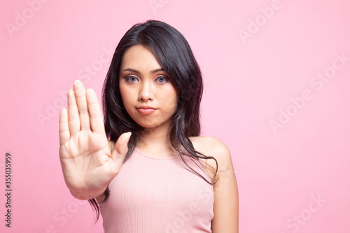 Portrait of an asian woman showing stop gesture.