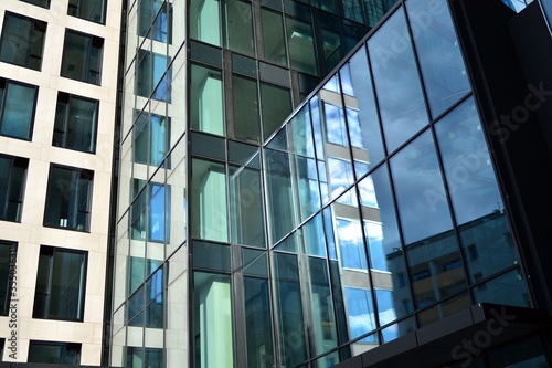 Facade texture of a glass mirrored office building. Fragment of the facade. Modern architecture of the office building.