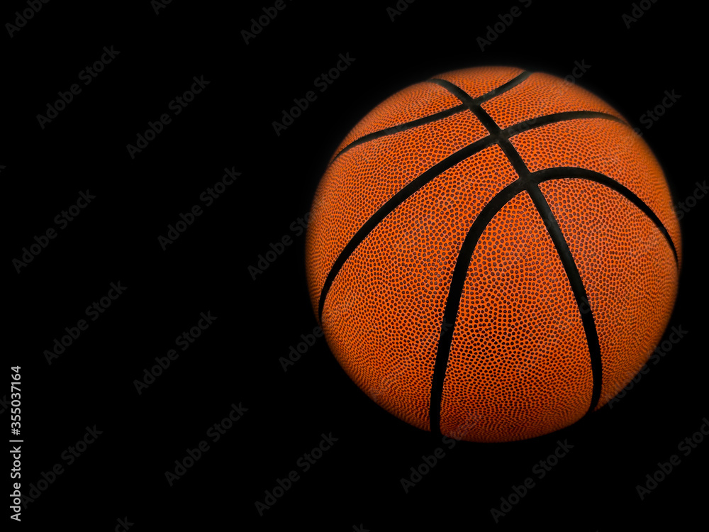 Basketball isolated on a black background as a sports and fitness symbol of a team leisure activity