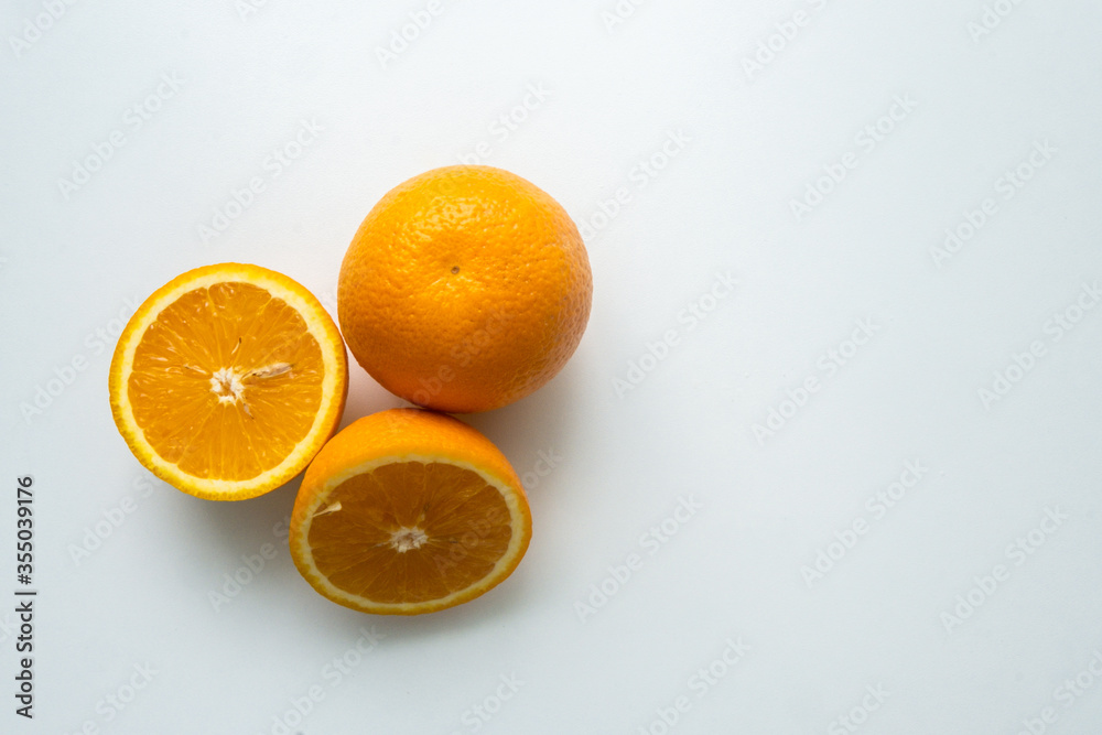 group of orange fruits isolated on a white table. cut orange. view from above group of orange fruits isolated on a white table. cut orange. view from above