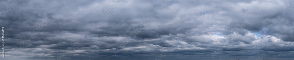 panorama of dramatic sky with clouds before a thunderstorm. Dark abstract background. panorama of dramatic sky with clouds before a thunderstorm. Dark abstract background.