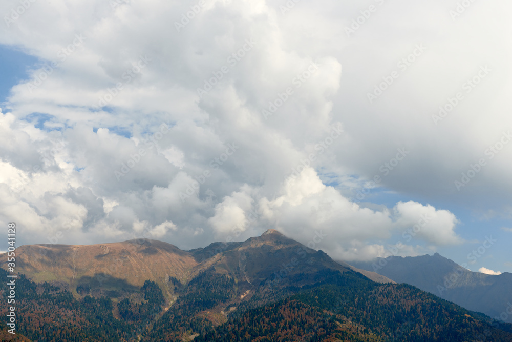 Nature and travel concept - High mountain and sky with clouds in autumn. Beautiful landscape..