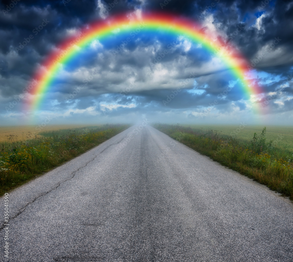 Rainbow over field road