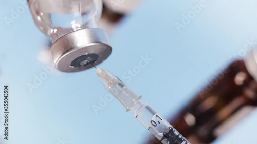 Medical drug being aspirated to a syringe as a treatment or vaccine