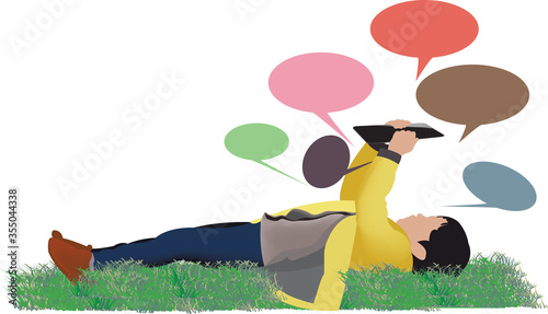 little girl lying down with tablet raised looks