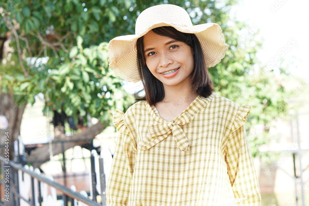 portrait Asian woman wearing yellow dress, happy to travel, smiling, seeing braces portrait Asian woman wearing yellow dress, happy to travel, smiling, seeing braces