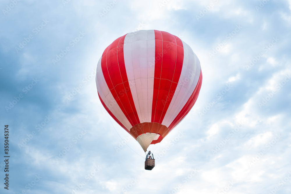 Balloon in the blue sky. Red balloon in the blue cloudy sky. Balloon in the blue sky. Red balloon in the blue cloudy sky.