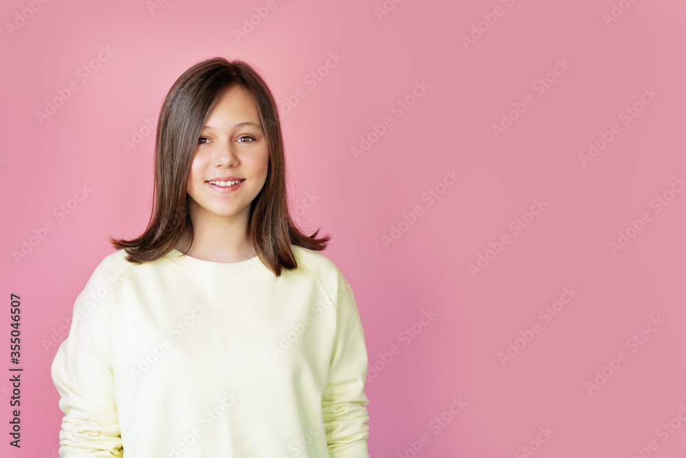 teen girl smiling over pink background teen girl smiling over pink background
