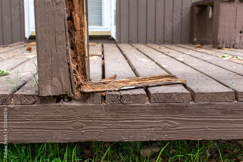 Old rotten damaged deck rail that is falling apart, dangerous and needs repaired or replaced.