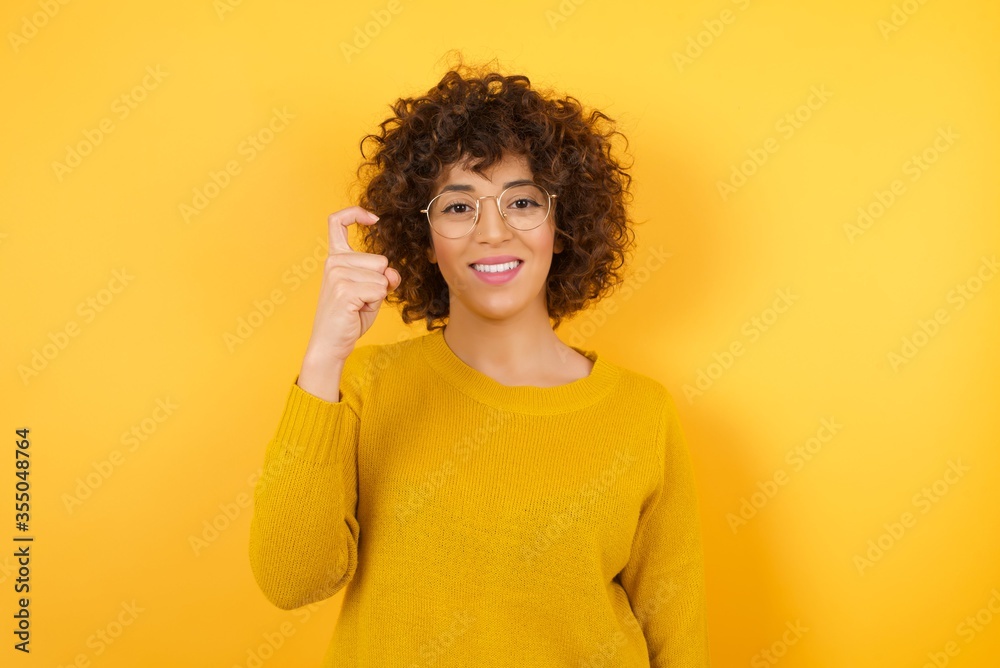 Young beautiful Cucasian businesswoman wearing yellow sweater and glasses standing against yellow background pointing up with fingers number nine in Chinese sign language Jiu Young beautiful Cucasian businesswoman wearing yellow sweater and glasses standing against yellow background pointing up with fingers number nine in Chinese sign language Jiu
