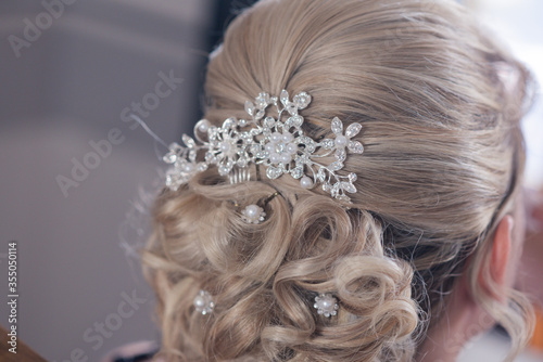 brides wedding hair up do from behind in a blonde haired woamn with decorative hair clip
