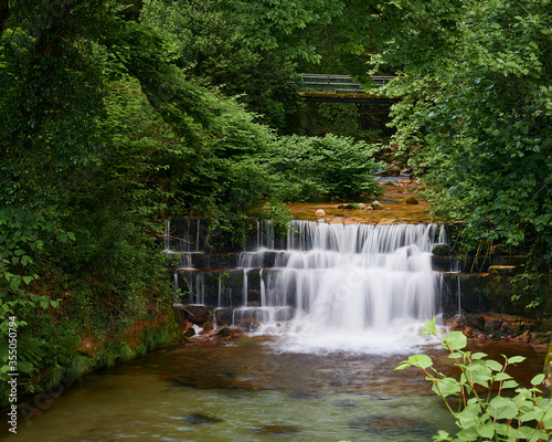 Waterfall of river ger  s that runs between the trees before fall throw the rock steps and enter the village