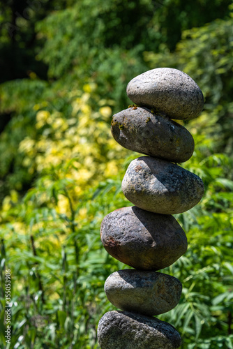 Stacked rocks in a garden, meditation focus for wellness 