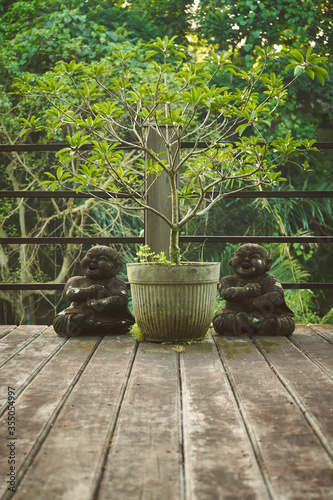 Outdoor garden design with buddha statues on the wood desk