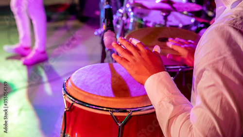 Photos Cuban musician playing drums on the stage, Havana, Cuba.