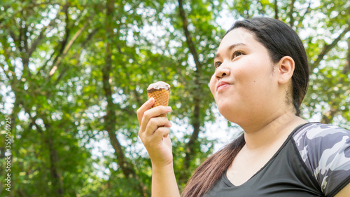 fat girl eat ice cream in close up face feeling delicious photo