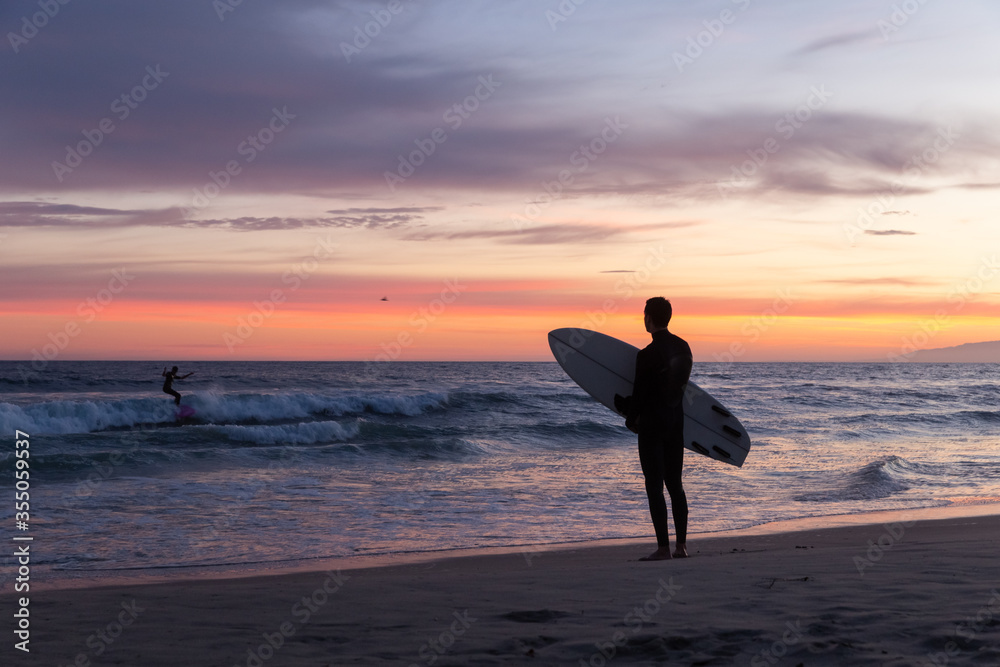 sunset silhouette of surfer on Venice Beach, California