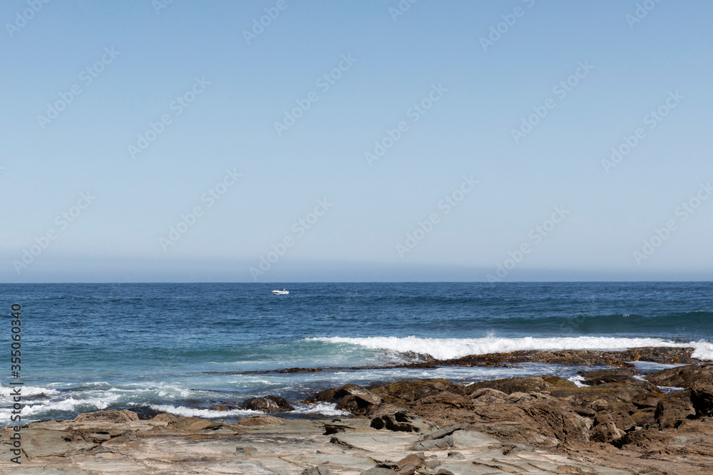 Isolated fishing boat in open water off the Australian coastline.