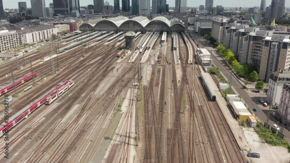AERIAL: Forward Flight over Frankfurt am Main, Germany Central Train Station Train Tracks on beautiful Summer Day with little Traffic due to Coronavirus Covid 19 Pandemic 