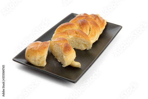 slices of egg bread on a black plate isolated on white 
