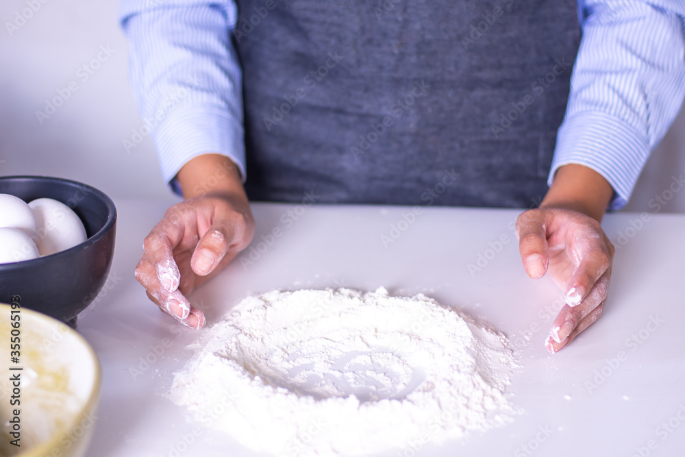 Close up of woman's hands cooking pastry with flour and eggs Close up of woman's hands cooking pastry with flour and eggs