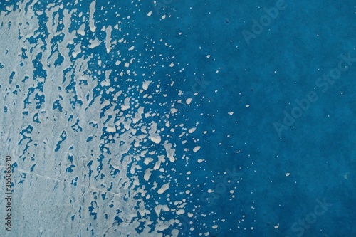 White paint splatter on the blue wall