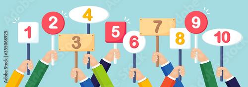 Human hand hold banner, placard with numeral alphabet. Signs with number. Card with amount of scores in tornament. Vote, contest, competition concept. Vector flat design
