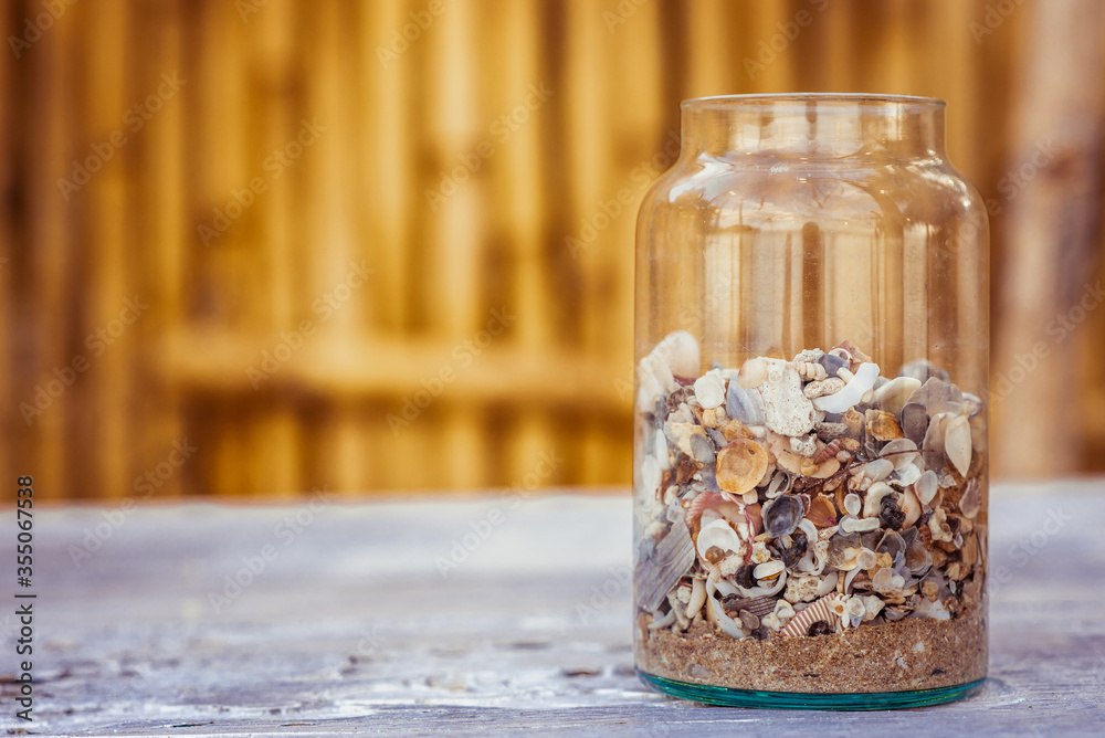 Glass jars that put shells on a wooden table
Glass jars that put shells on a wooden table