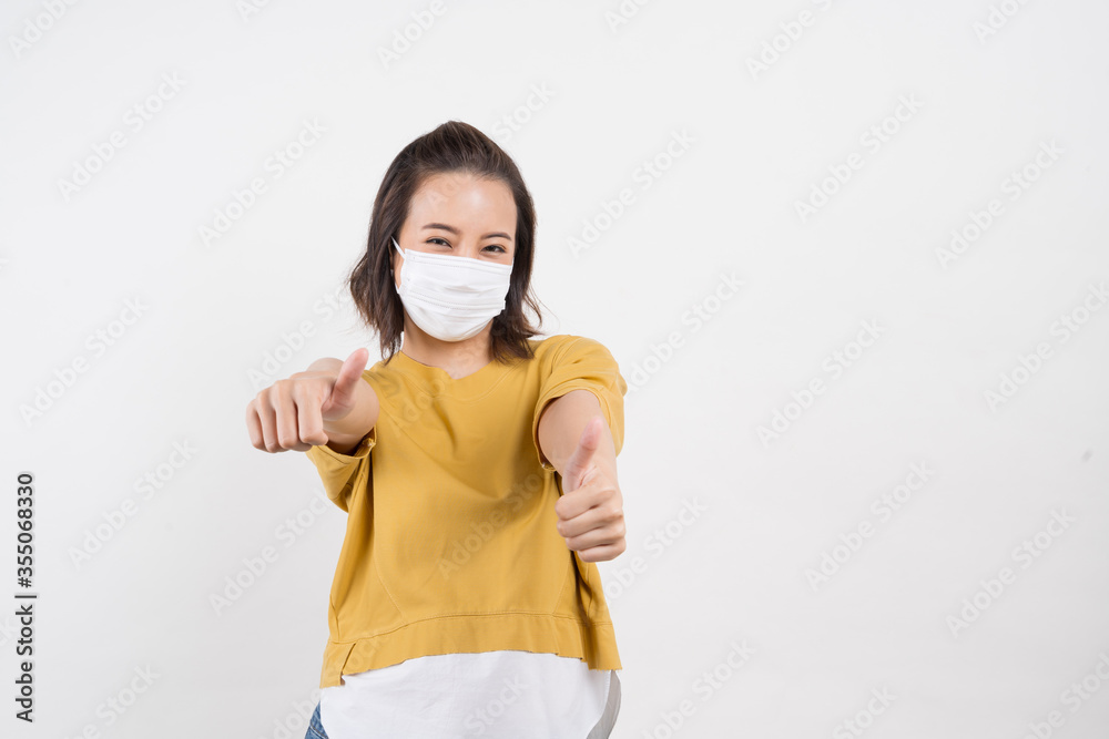 Young Asian woman wearing hygienic mask to prevent infection corona virus Air pollution pm2.5 she wearing a yellow T-shirt shoot in shot isolated on white background Young Asian woman wearing hygienic mask to prevent infection corona virus Air pollution pm2.5 she wearing a yellow T-shirt shoot in shot isolated on white background