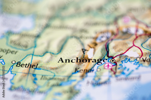 Shallow depth of field focus on geographical map location of Anchorage city United States of America USA continent on atlas