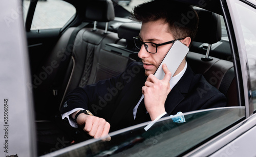 Young businessman talking on phone in luxury ar