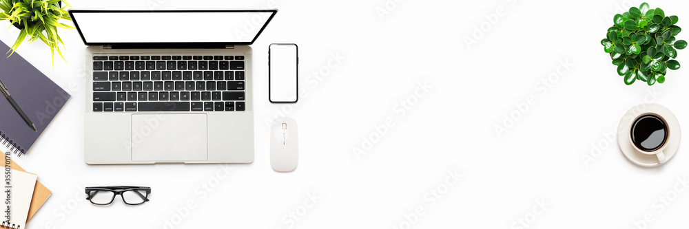 Flat lay of White office desk table or workplace with laptop, and smartphone with equipment other office supplies with copy right space and white blank screen, top view Flat lay of White office desk table or workplace with laptop, and smartphone with equipment other office supplies with copy right space and white blank screen, top view