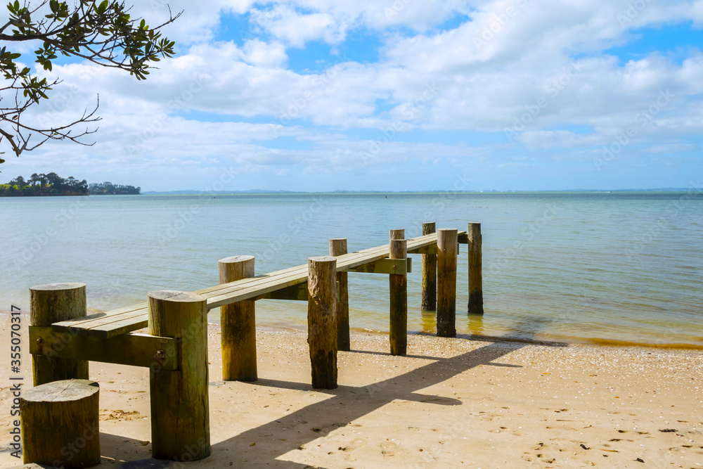 Small Wooden Wharf at Awhitu Regional Park Beach during Low Tide; Kauritutahi Beach; Auckland New Zealand