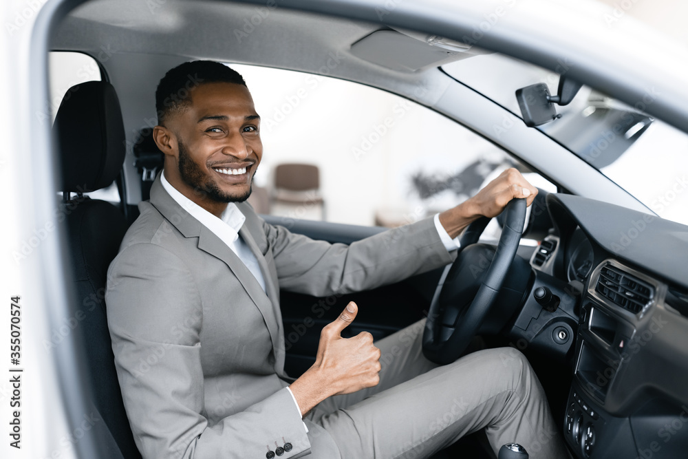 African Businessman Gesturing Thumbs Up Sitting In Driver's Seat