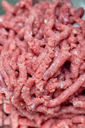 Extreme close-up view of raw minced meat after meat grinder