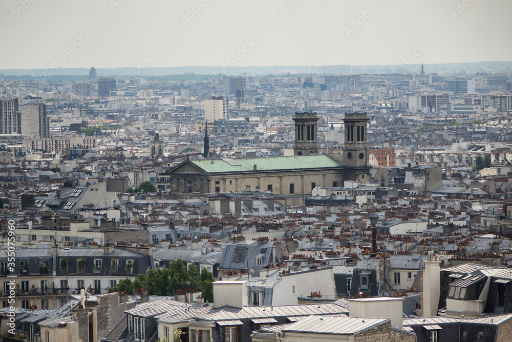 Paris city scape of rooftops. Buildings of Paris from high point of view. Various roofs and houses of Paris