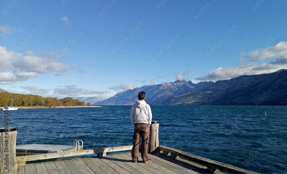 A man standing around lake Wakatipu New Zealand A man standing around lake Wakatipu New Zealand