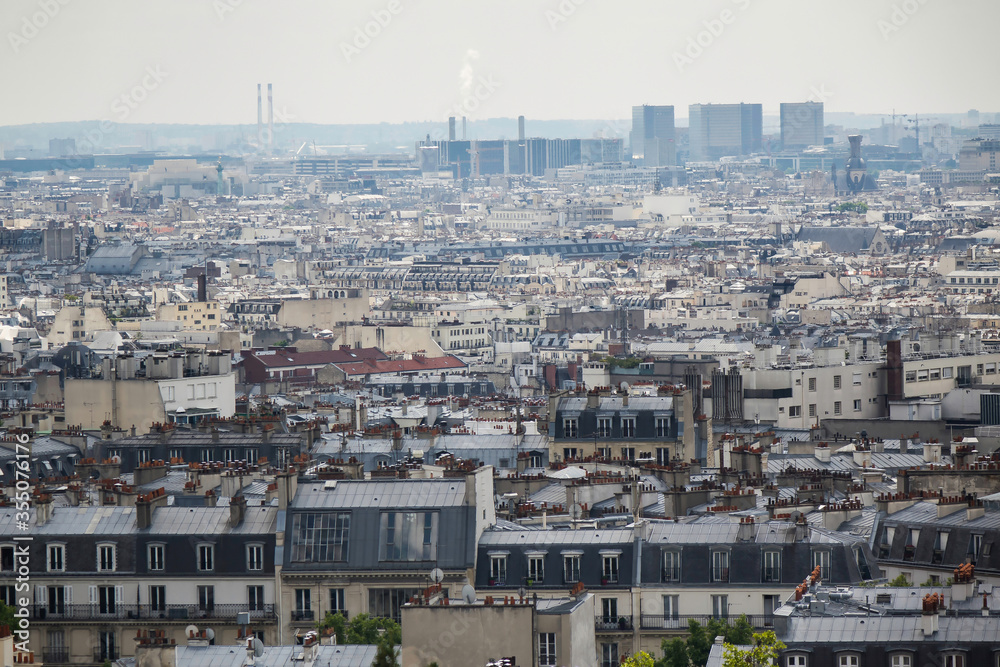 Paris city scape of rooftops. Buildings of Paris from high point of view. Various roofs and houses of Paris