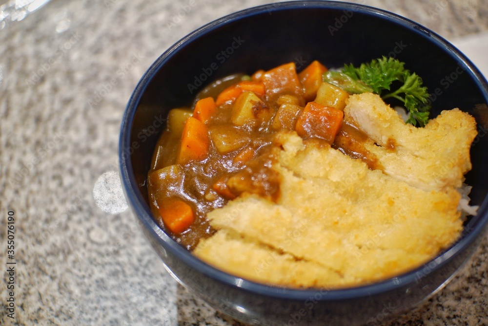 Close up of chicken katsu curry in a bowl. Close up of chicken katsu curry in a bowl.