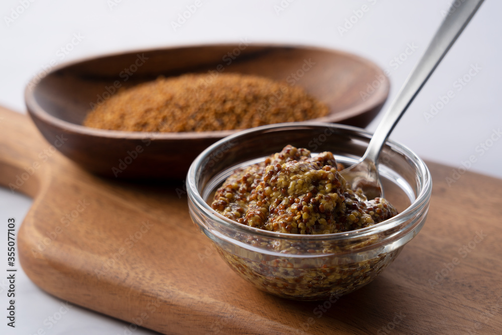 Mustard sauce placed on a cutting board.