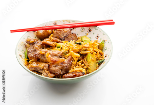 Chinese style grilled pork noodles on a white background