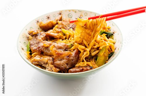 Chinese style grilled pork noodles on a white background
