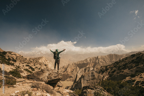 Upper mustang - Kingdom of Lo. Trekking in ancient Tibet. Sandstone massif in Nepal. high quality photo. Anapurna area. wild place.close territory. man backpacker in the mountains enjoys the view